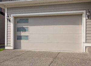 a newly repaired, tan-colored garage door on large family home