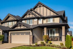 a brown colored garage door with windows on large family home